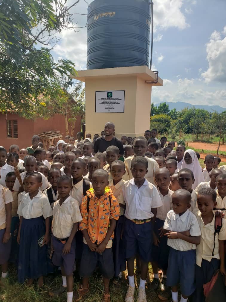Schoolchildren gathered around the completed Ng’ombeni water point