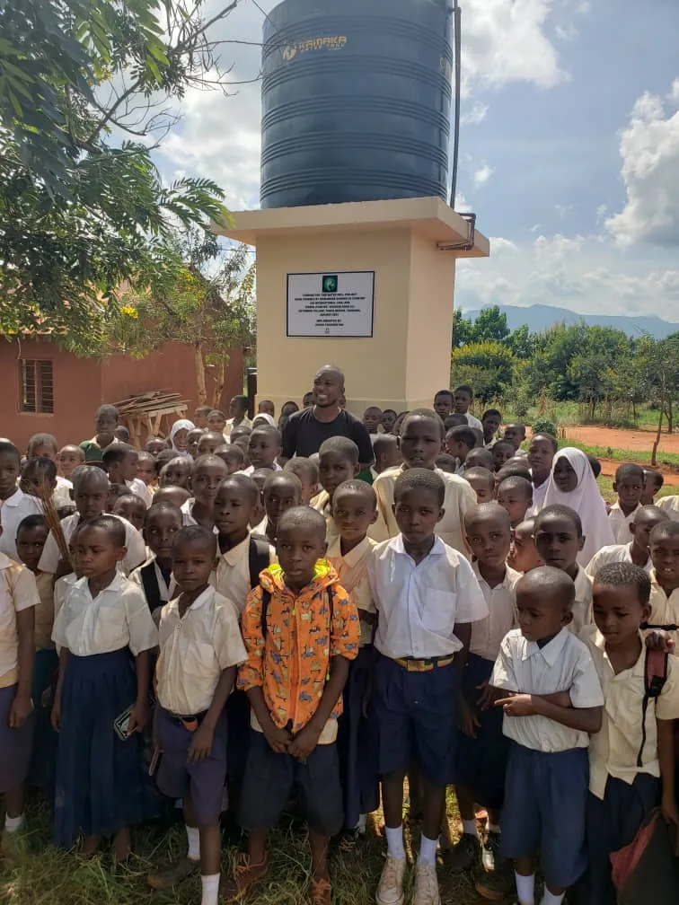 Schoolchildren gathered around the completed Ng’ombeni water point