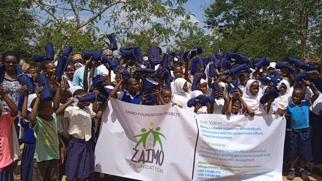 Juma from Rufiji standing with his family after receiving aid